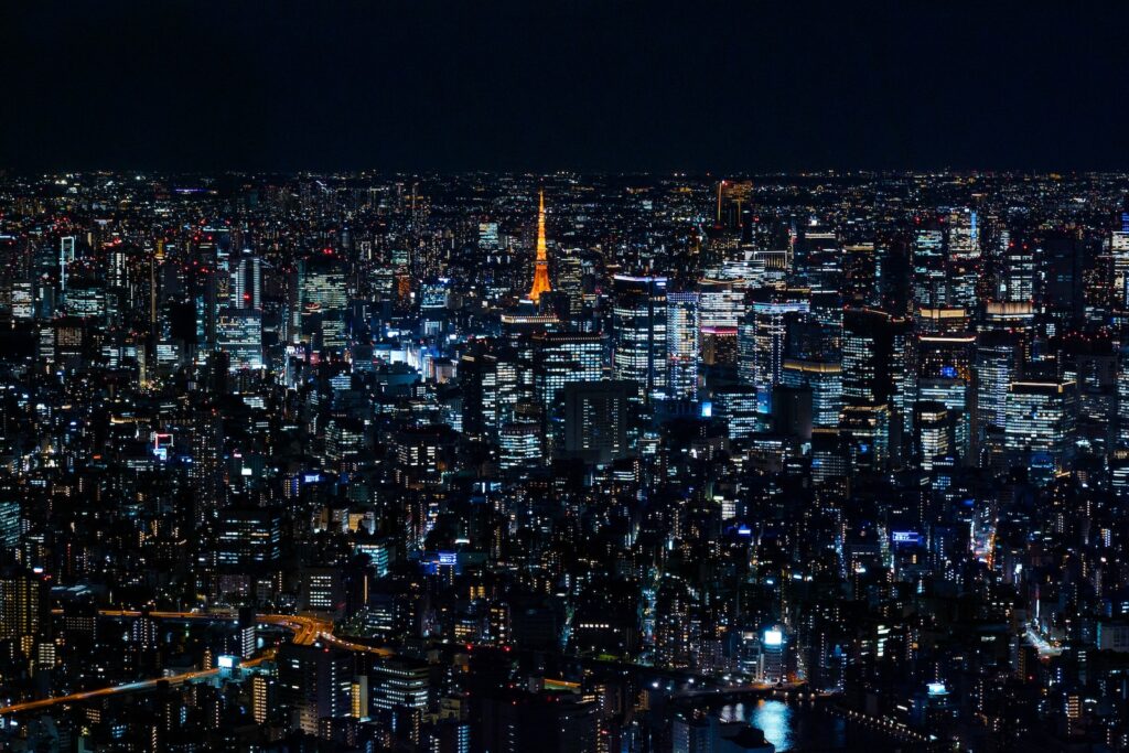 a view of a city at night from the top of a skyscraper