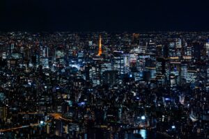 a view of a city at night from the top of a skyscraper